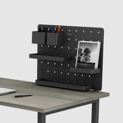 Metal desktop organizer mounted at the edge of Needs 2.0 table.
