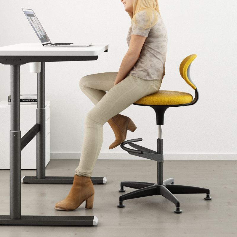 a lady sitting on the ginko high stool working on the Vertigo R height adjustable table