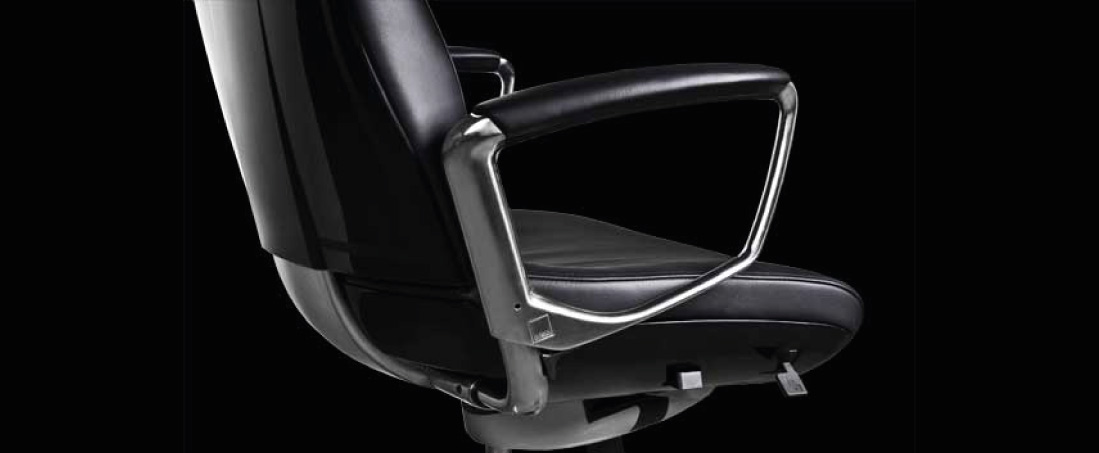 closeup of liven office chair polished armrest with leather padding