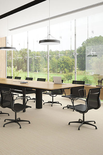 Black Como Air office chairs with Vertigo height adjustable conference table in a modern conference room with full height glass windows