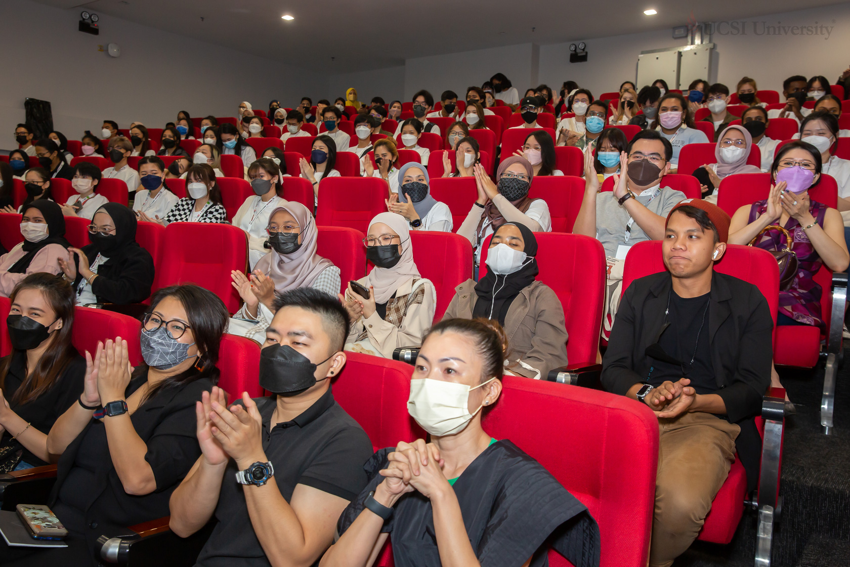 Audience clapping hands in UCSI University auditorium hall