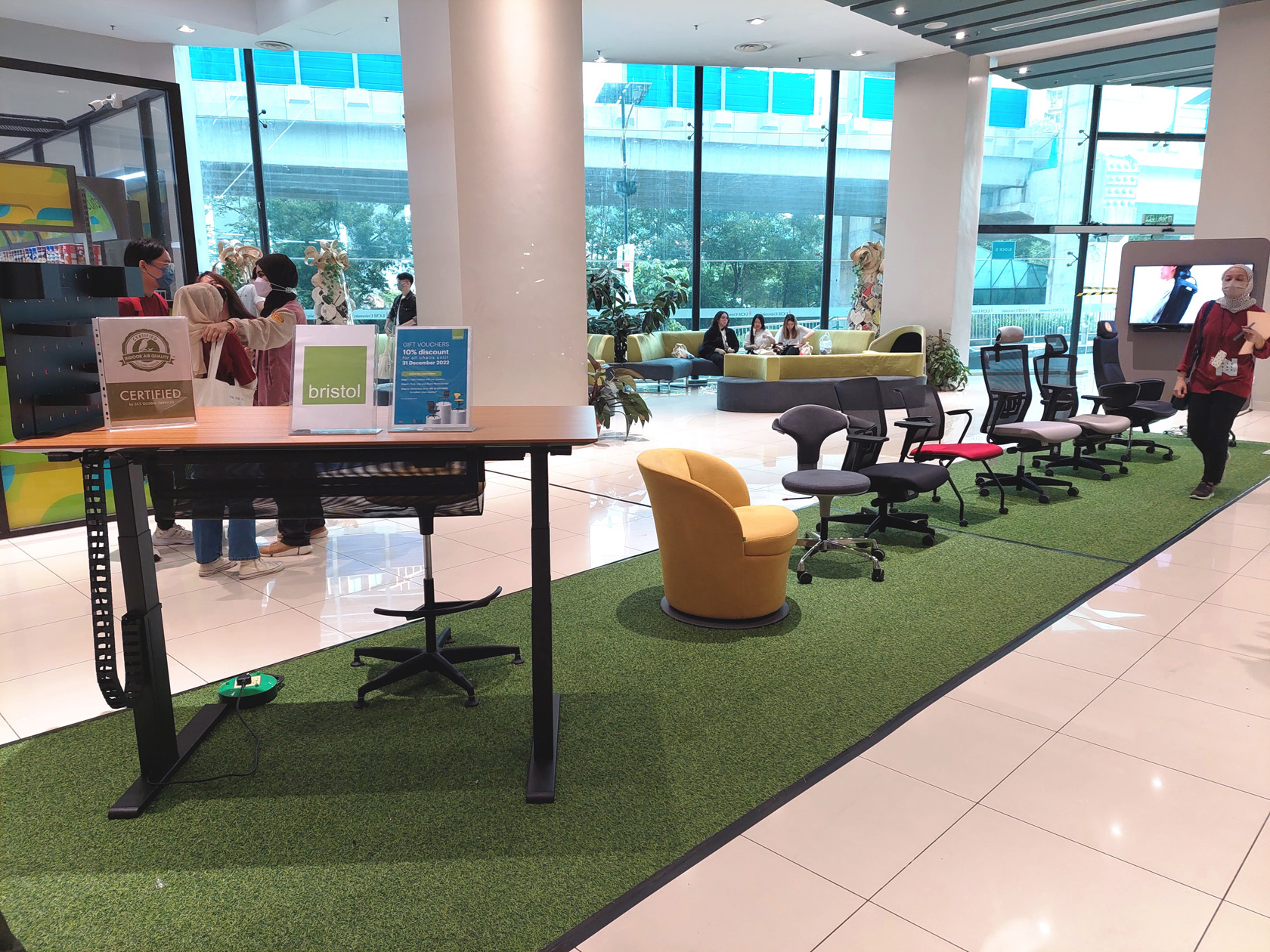 Bristol office chairs and table displayed on a green carpet in USCI University