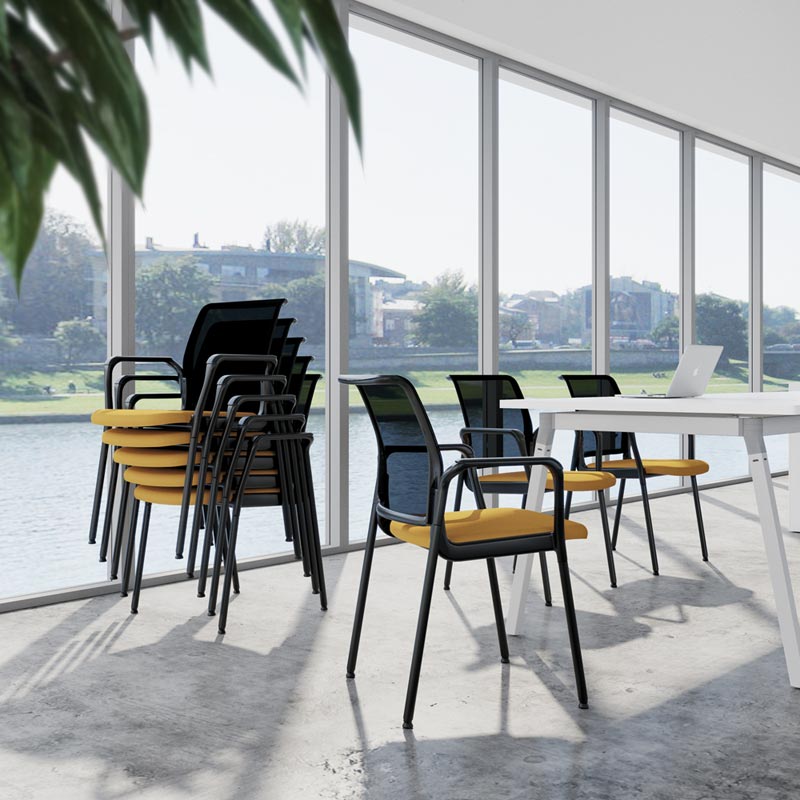 girs air chairs stacked up on the side and beside the Artiv meeting table