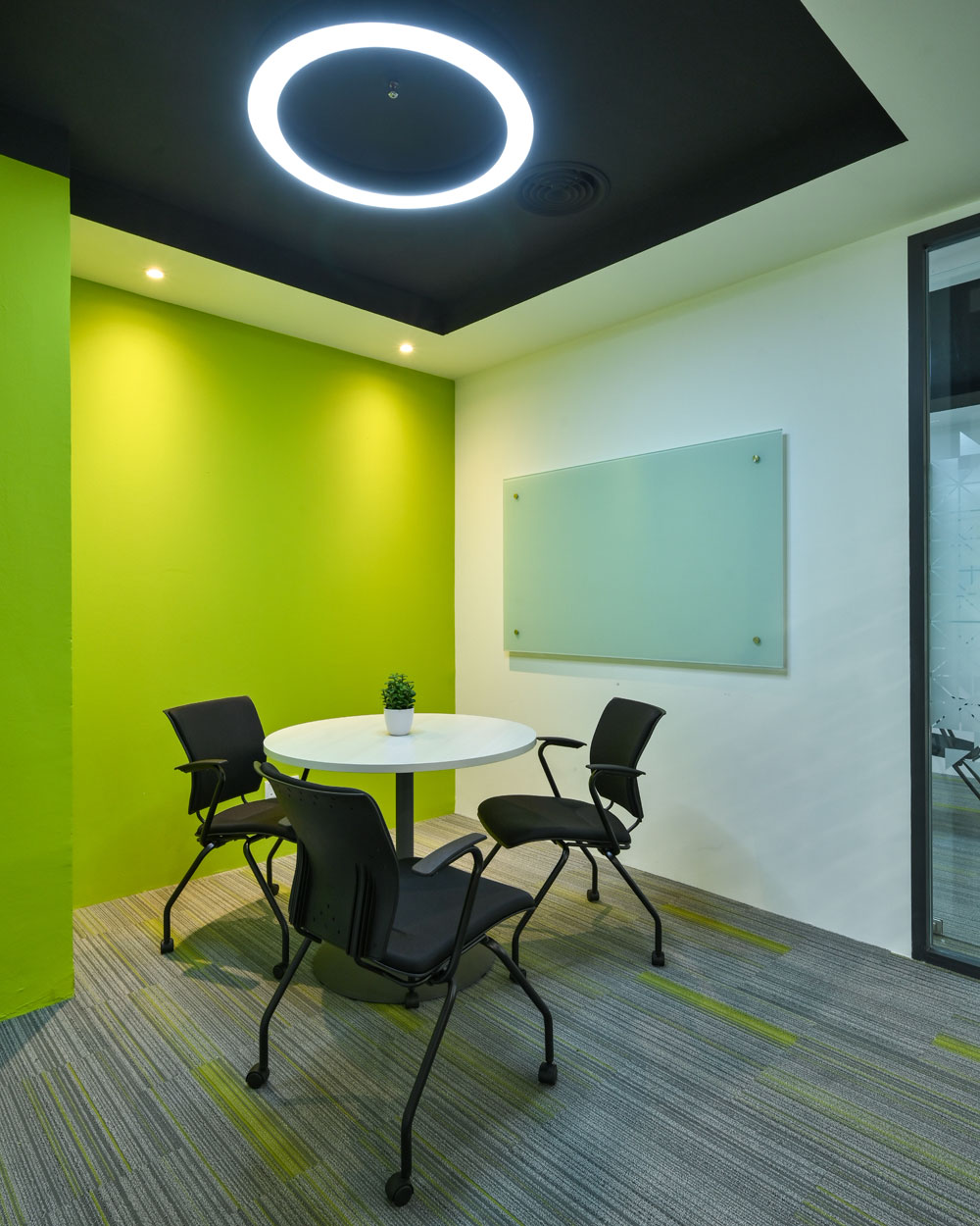 Green interior discussion room with Kleiber chair