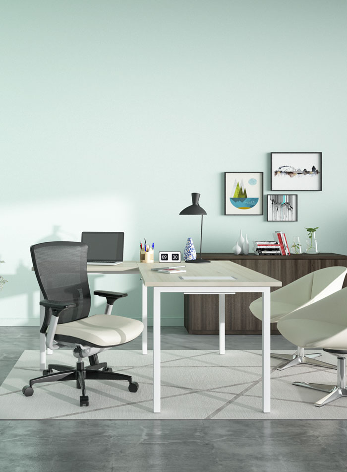 Needs 2.0 table with Soul office chair in a pale green office room